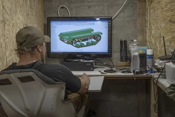 Serhii, chief engineer of design and production bureau “UkrPrototyp”, works on 3D model of a a car-sized 800-kilogram (1,750-pound) prototype drone, in the north of Ukraine, Thursday, June 27, 2024. Facing manpower shortages and uneven international assistance, Ukraine is struggling to halt Russia’s incremental but pounding advance in the east and is counting heavily on innovation at home. (AP Photo/Anton Shtuka)