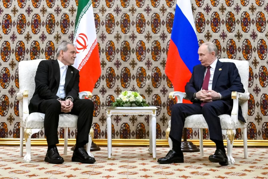 Russian President Vladimir Putin, right, and Iranian President Masoud Pezeshkian talk during their meeting on the sidelines of an international forum in Ashgabat, Turkmenistan, Friday, Dec. 12, 2025. (Kristina Kormilitsyna/Sputnik, Kremlin Pool Photo via AP)
