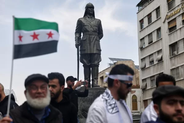 A statue of Yusuf al-Azma, a Syrian military leader who died resisting French forces in 1920, overlooks a demonstration calling for improved living conditions and public services at Yusuf al-Azma Square in Damascus, Syria, Friday, April 17, 2026. (AP Photo/Ghaith Alsayed) A statue of Yusuf al-Azma, a Syrian military leader who died resisting French forces in 1920, overlooks a demonstration calling for improved living conditions and public services at Yusuf al-Azma Square in Damascus, Syria, Friday, April 17, 2026. (AP Photo/Ghaith Alsayed)
