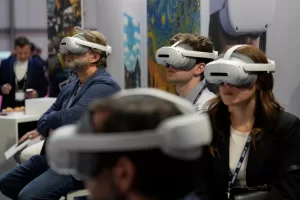 Visitors try AI headset at the Europe’s largest artificial intelligence event, AI Week 2026, in Rho, near Milan, Italy, Tuesday, May 19, 2026. (AP Photo/Luca Bruno)