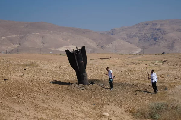 People take photos of the wreckage of an Iranian missile that landed near the West Bank city of Jericho Monday, June 8, 2026. (AP Photo/Mahmoud Illean)
