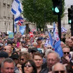 Demonstrators gather holding flags and placards as they attend a protest against antisemitism and extremism, in London, Sunday, May 10, 2026.(AP Photo/Alberto Pezzali)