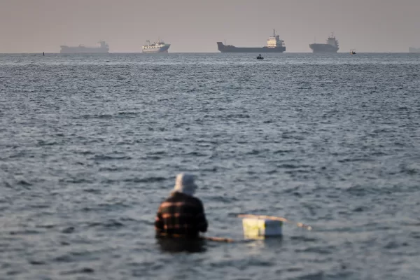 A person sits on shallow water as cargo and commercial vessels are anchored in the Strait of Hormuz off Bandar Abbas, Iran, Monday, June 8, 2026. (Amirhosein Khorgooi/ISNA via AP) A person sits on shallow water as cargo and commercial vessels are anchored in the Strait of Hormuz off Bandar Abbas, Iran, Monday, June 8, 2026. (Amirhosein Khorgooi/ISNA via AP)