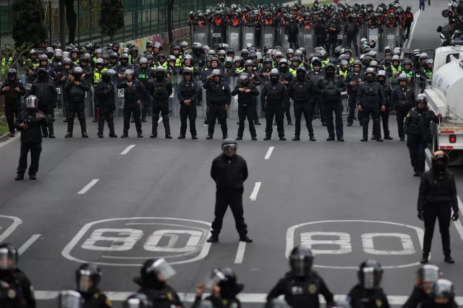 Police block an avenue to prevent protesting teachers from marching to the stadium that will host the opening match of the FIFA World Cup in Mexico City, Tuesday, June 9, 2026. (AP Photo/Eduardo Verdugo)