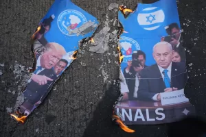 A picture of U.S. President Donald Trump, left, and Israeli Prime Minister Benjamin Netanyahu burns as protesters hold a rally to condemn the Iran war near the U.S. Embassy in Manila, Philippines on Friday March 6, 2026. (AP Photo/Aaron Favila)