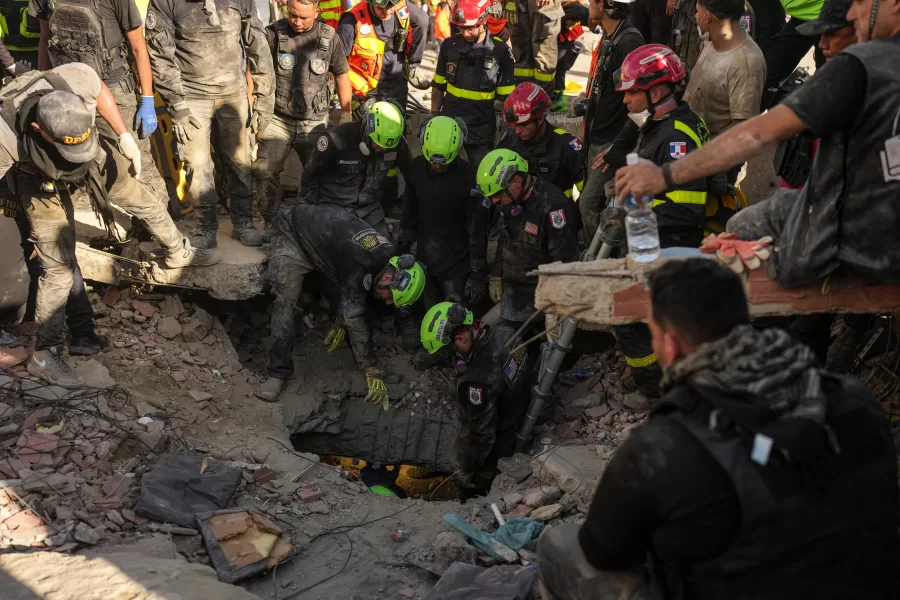U.S. and French search-and-rescue personnel work to reach earthquake survivors trapped in the rubble in La Guaira, Venezuela, Sunday, June 28, 2026. (AP Photo/Matias Delacroix)