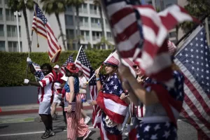 Participants carrying American flags join the festivities during the Independence Day Parade march along Main Street in Santa Monica, Calif. on Friday, July 4, 2025. (AP Photo/Richard Vogel) Participants carrying American flags join the festivities during the Independence Day Parade march along Main Street in Santa Monica, Calif. on Friday, July 4, 2025. (AP Photo/Richard Vogel)