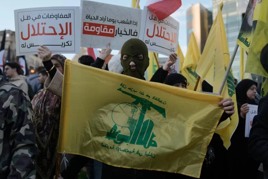 A Hezbollah supporter holds a group flag during a protest condemning recent Israeli military actions in Lebanon and calling on the international community to intervene as tensions escalate along the southern border, outside the headquarters of the U.N. Economic and Social Commission for Western Asia, ESCWA, in Beirut, Lebanon, Wednesday, Feb. 4, 2026. (AP Photo/Bilal Hussein)