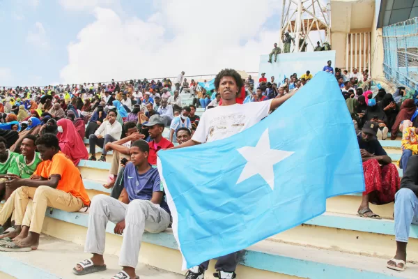 A man holds the flag of Somalia as people gather at the Mogadishu stadium while they protest Israel’s recognition of Somalia’s breakaway region of Somaliland as an independent nation, in Mogadishu, Somalia, Tuesday, Dec. 30, 2025. (AP photo/Farah Abdi Warsameh)