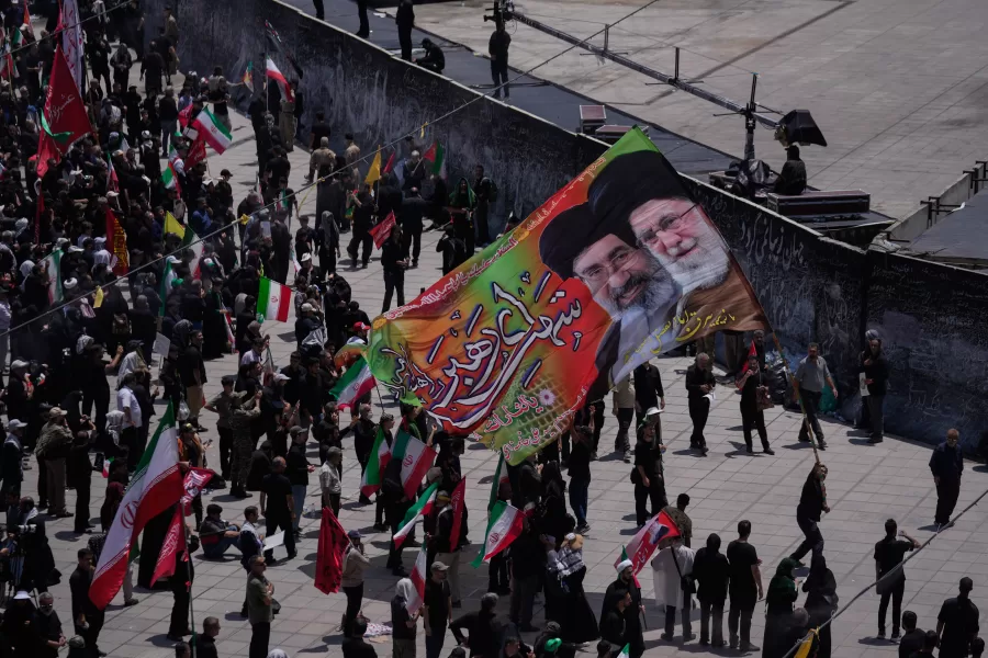 Mourners carry a large banner depicting the late Iranian Supreme Leader Ayatollah Ali Khamenei, right, and Iranian Supreme Leader Ayatollah Mojtaba Khamenei during the dayslong funeral ceremonies for the late supreme leader and members of his family outside the Imam Khomeini Mosalla Grand Mosque in Tehran, Iran, Sunday, July 5, 2026. (AP Photo/Altaf Qadri)