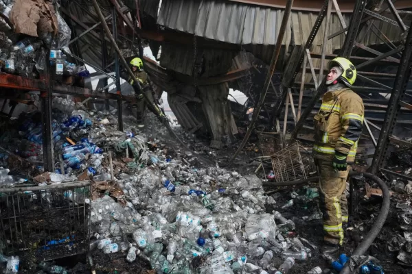 Firefighters work at the site of a fire after Russian missiles hit a food warehouse near Kyiv, Ukraine, Wednesday, Aug. 5, 2026. (AP Photo/Efrem Lukatsky)