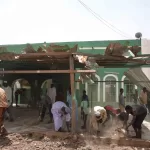 People clear debris from a mosque that residents said was damaged in a drone strike in Khartoum, Sudan, Wednesday, Aug. 12, 2026. (AP Photo/Marwan Ali)