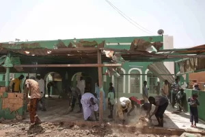 People clear debris from a mosque that residents said was damaged in a drone strike in Khartoum, Sudan, Wednesday, Aug. 12, 2026. (AP Photo/Marwan Ali)