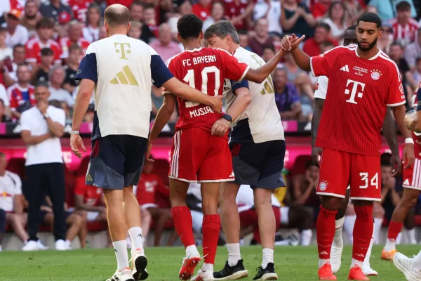 Munich’s Jamal Musiala, center, leaves the pitch due to an injury during a pre-season soccer match between FC Bayern Munich and RB Leipzig in Munich, Germany, Saturday, Aug. 15, 2026. (Karl-Josef Hildenbrand/dpa via AP)