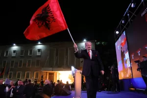 Former Prime Minister and Democratic Party leader Sali Berisha holds the Albanian flag after a speech to his supporters demanding the resignation of Albania’s government during in a rally in Tirana, Albania, Friday, April 17, 2026. (AP Photo/Hameraldi Agolli) Former Prime Minister and Democratic Party leader Sali Berisha holds the Albanian flag after a speech to his supporters demanding the resignation of Albania’s government during in a rally in Tirana, Albania, Friday, April 17, 2026. (AP Photo/Hameraldi Agolli)