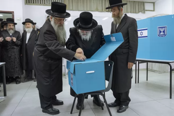 Ultra-Orthodox Jews watch their Rabbi Israel Hager votes during Israel elections in Bnei Brak, Tuesday, Nov. 1, 2022. Israel is holding its fifth election in less than four years. (AP Photo/Oded Balilty)