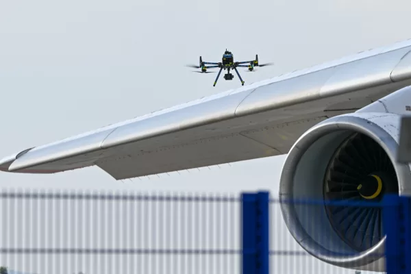 A police drone checks an aircraft at Leipzig/Halle Airport, where a drone with an explosive device was found and a detonator was removed from the object, in Schkeuditz, Germany, Wednesday Aug. 5, 2026. (Hendrik Schmidt/dpa via AP)